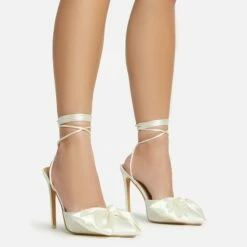 EGO Bowdown Lace Up Bow Detail Pointed Toe Stiletto Heel In Cream Satin
