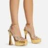 EGO Show-Ahead Clear Perspex Strap Diamante Detail Platform Flared Block Heel In Gold Faux Leather
